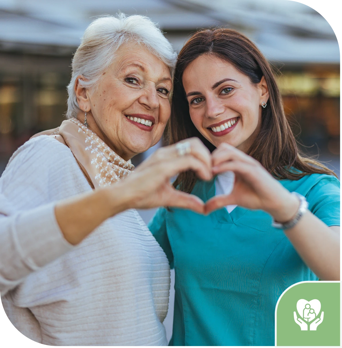 Elderly woman and nurse making heart shape