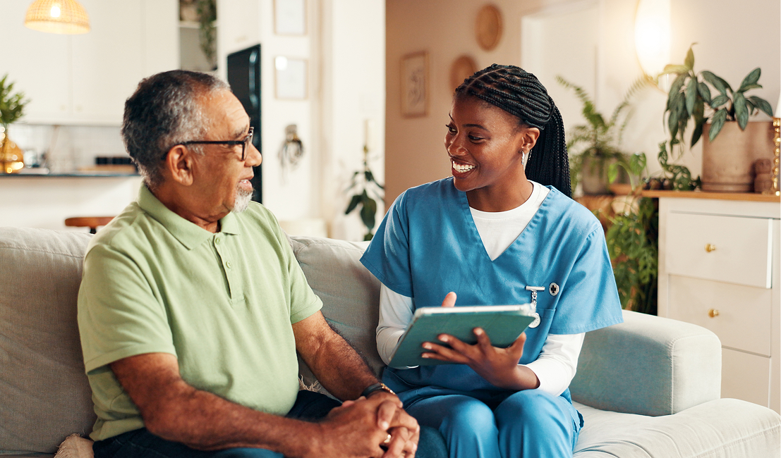 Healthcare worker consulting with senior patient